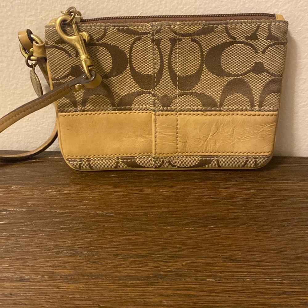 Tan Coach wristlet.